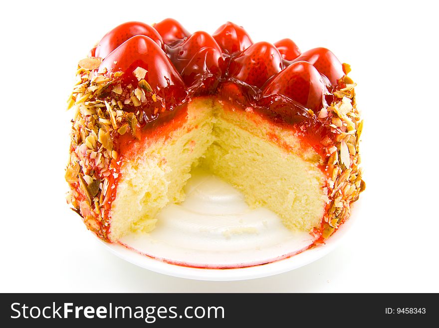 Single delicious looking strawberry topped new york style cheesecake on a white background. Single delicious looking strawberry topped new york style cheesecake on a white background