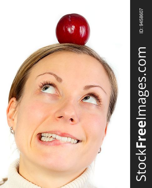 Remorse concept, a girl looking on a healthy fruit on her head (isolated on white). Remorse concept, a girl looking on a healthy fruit on her head (isolated on white)