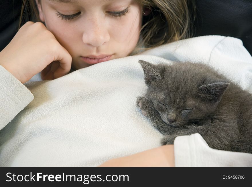 Young girl waits patiently for her new kitten to wake. Young girl waits patiently for her new kitten to wake