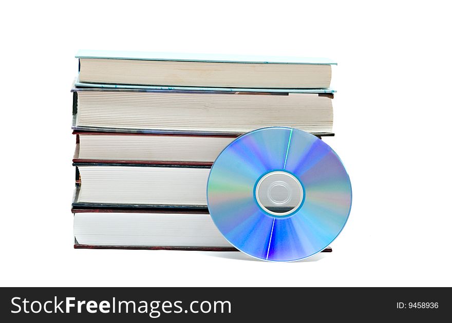 Pile of books and DVD disk as symbols of old and new methods of information storage