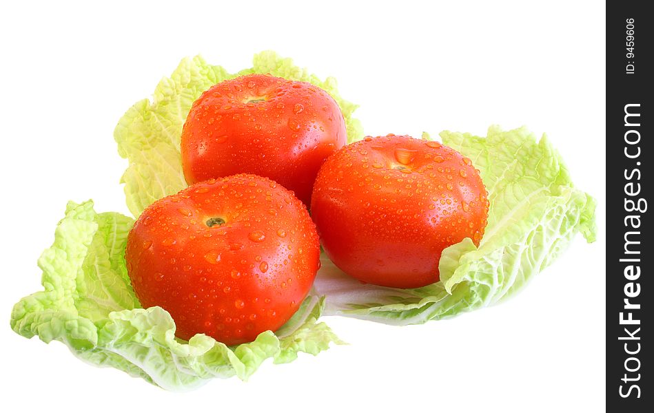 Three tomatoes on salad, on a white background, it is isolated. Three tomatoes on salad, on a white background, it is isolated.