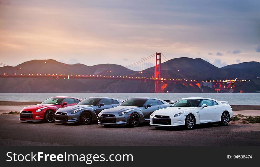 A row of cars on a street with the Golden Gate bridge on the background. A row of cars on a street with the Golden Gate bridge on the background.