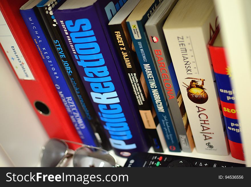 A bookshelf with books and other items. A bookshelf with books and other items.