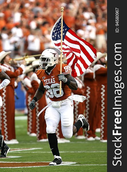 Nfl Player Holding U.s.a. Flag On Field