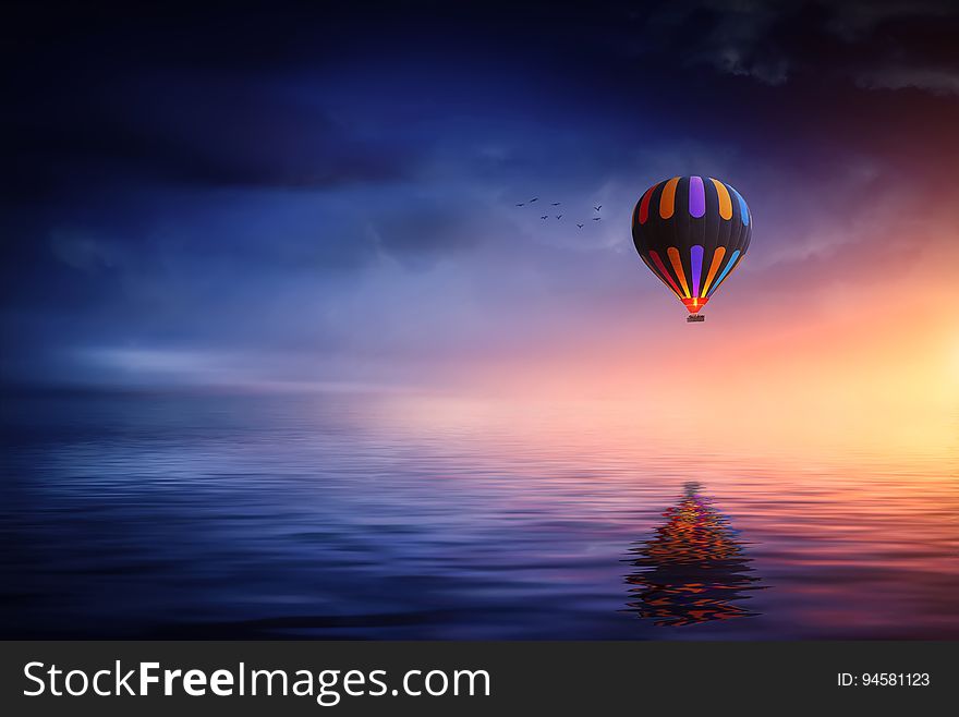 An illustration of a hot air balloon over water.
