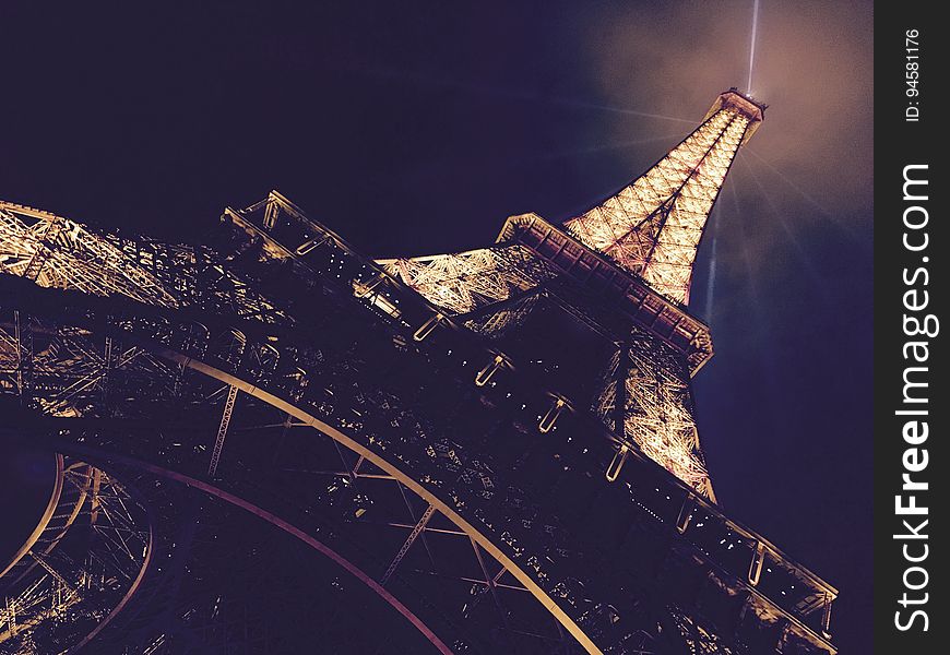 The Eiffel tower with lights in Paris, France, at night. The Eiffel tower with lights in Paris, France, at night.