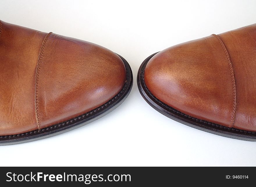Pair of brown shoes on white