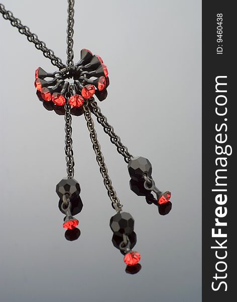 Close up of a modern black necklace with red gemstones. Close up of a modern black necklace with red gemstones