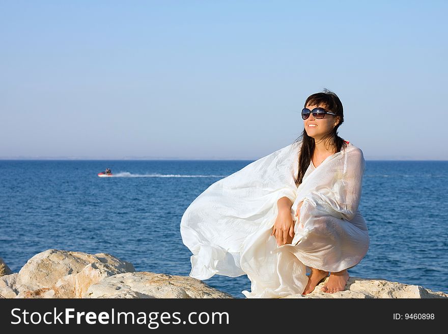 Beautifu girl in white sarong being on the beach. Beautifu girl in white sarong being on the beach