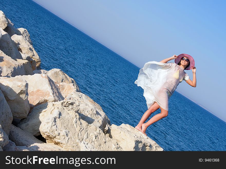 Portrait of the girl in white sarong standing on the big stone