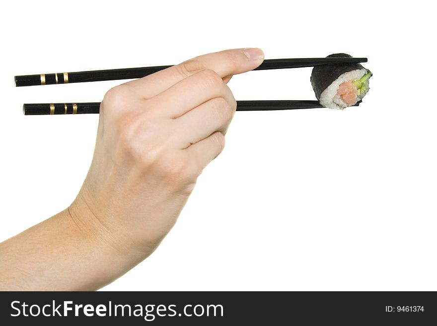 Hand with chopstick takes japanese sushi on white background