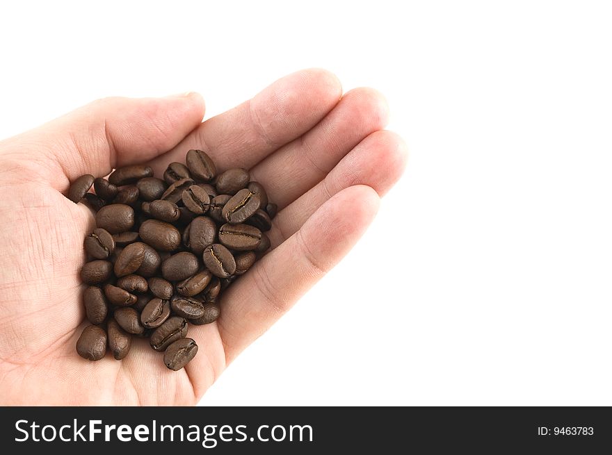 Handful of coffee beans, white background, close up.