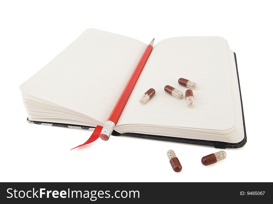 Open diary with pencil and pills isolated. Open diary with pencil and pills isolated