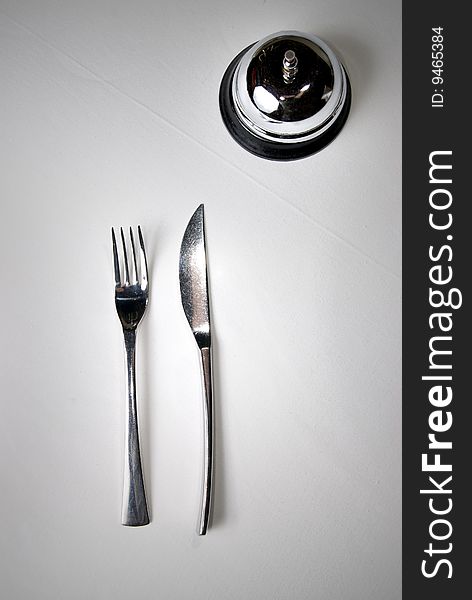 Fork and knife on table with restaurant ring. Fork and knife on table with restaurant ring