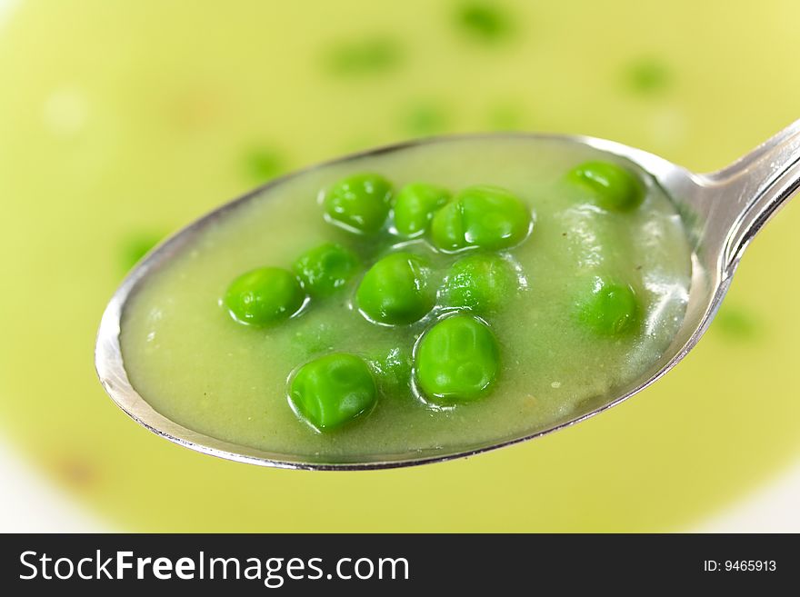 Bowl Of Pea Soup Garnished With  Cream And Crouton