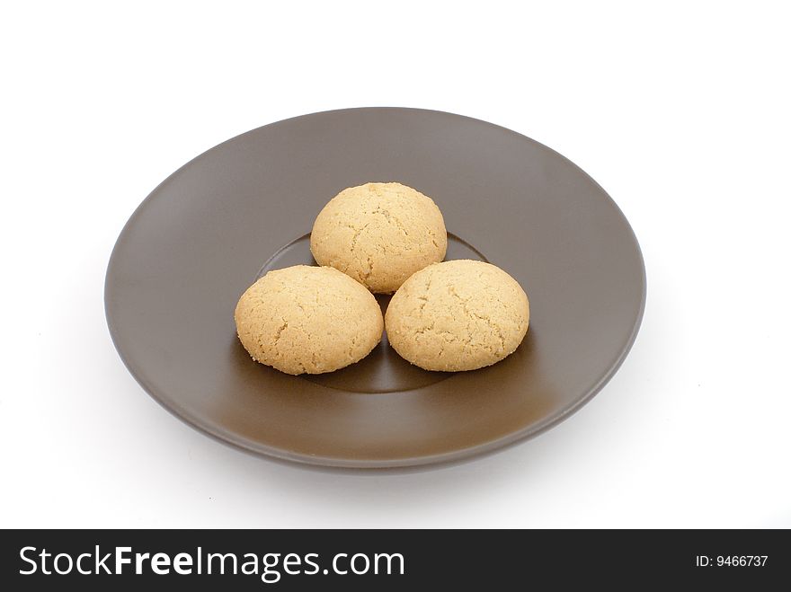 Brown saucer with three biscuits. Brown saucer with three biscuits