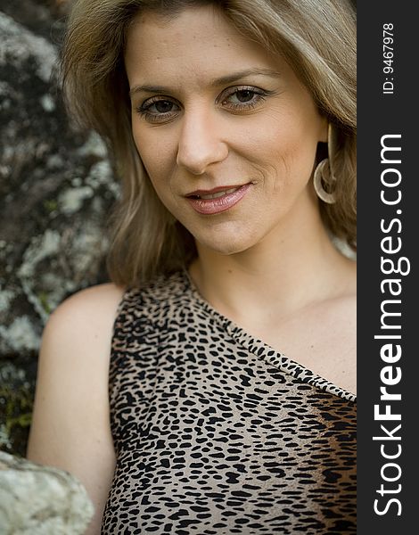 A very pretty and young blond brazilian woman wearing a leopard skin like blouse. A very pretty and young blond brazilian woman wearing a leopard skin like blouse.