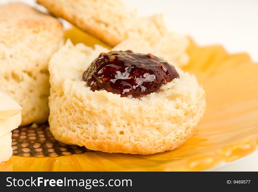Buttermilk Biscuits with raspberry preserves on Sunflower plate