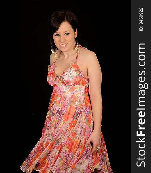 A formal portrait of a dark haired teenage girl. Black background. A formal portrait of a dark haired teenage girl. Black background