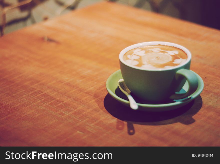 Cup Of Coffee On Wooden Table