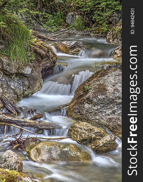 Clear Running Water In The Middle Of Brown Stones