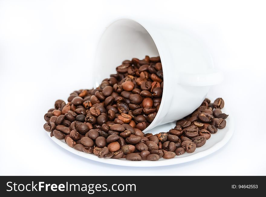 Coffee Beans On White Ceramic Mug And Plate