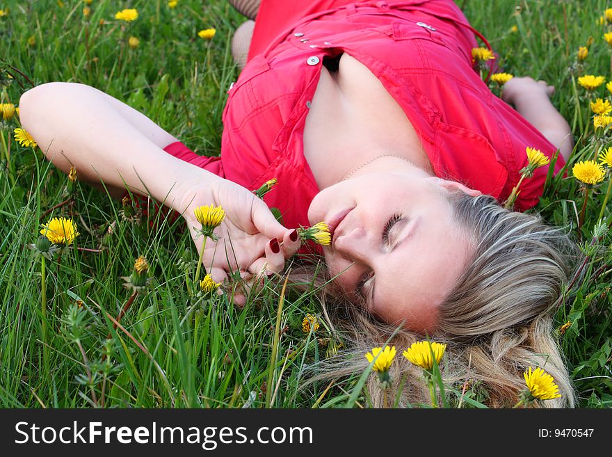 Young girl lying in dandelion meadow