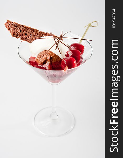Dessert creation in a glas with cherry