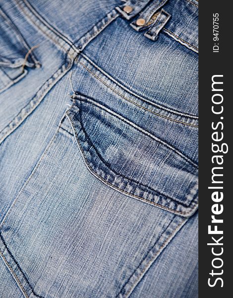 Old blue jeans with pocket and button