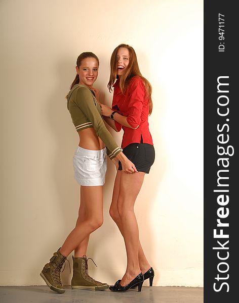 Two attracive young slim girls: sport style versus classic. Two attracive young slim girls: sport style versus classic