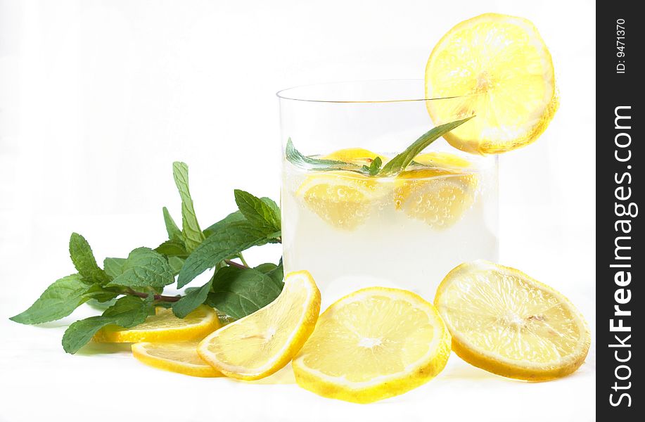 Lemonoade with lemon slice, ice and mint on white background. Lemonoade with lemon slice, ice and mint on white background