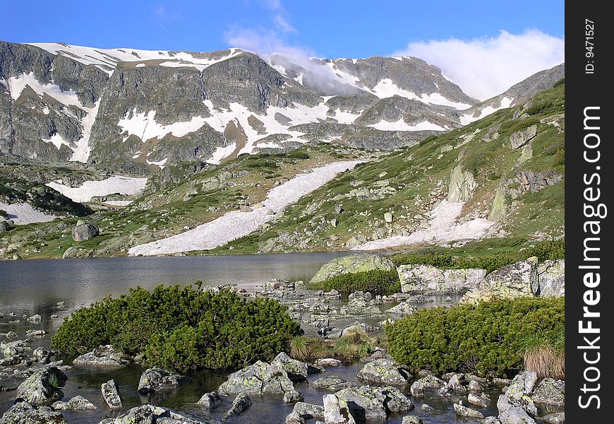 Snowy peaks reflected in the lake