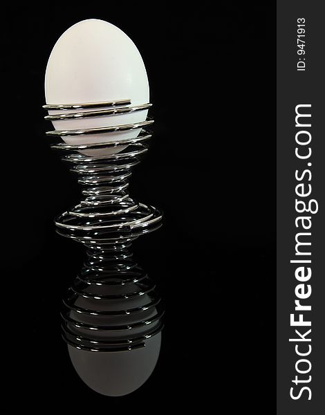 Reflection of a white egg on egg cup. Reflection of a white egg on egg cup