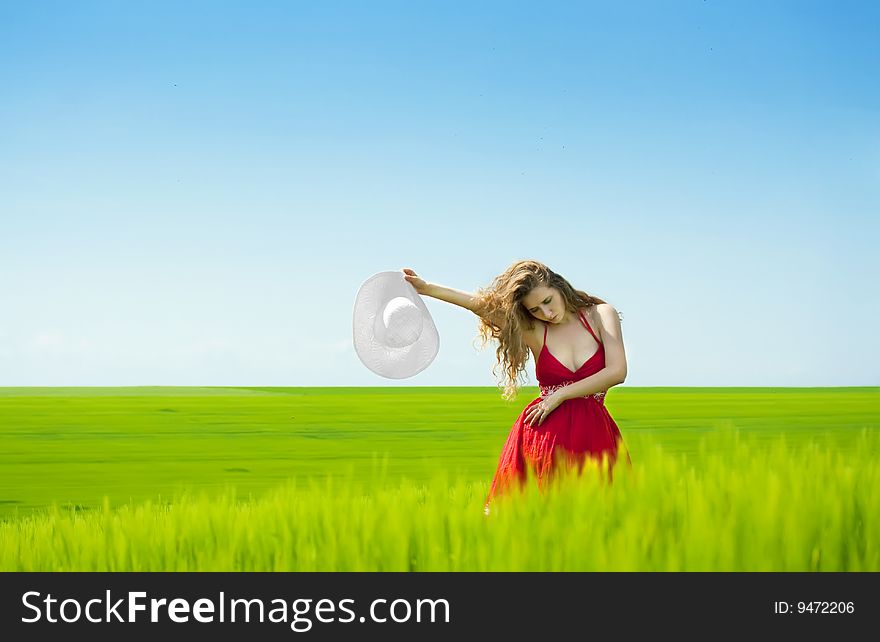 woman enjoying summertime in green field. woman enjoying summertime in green field