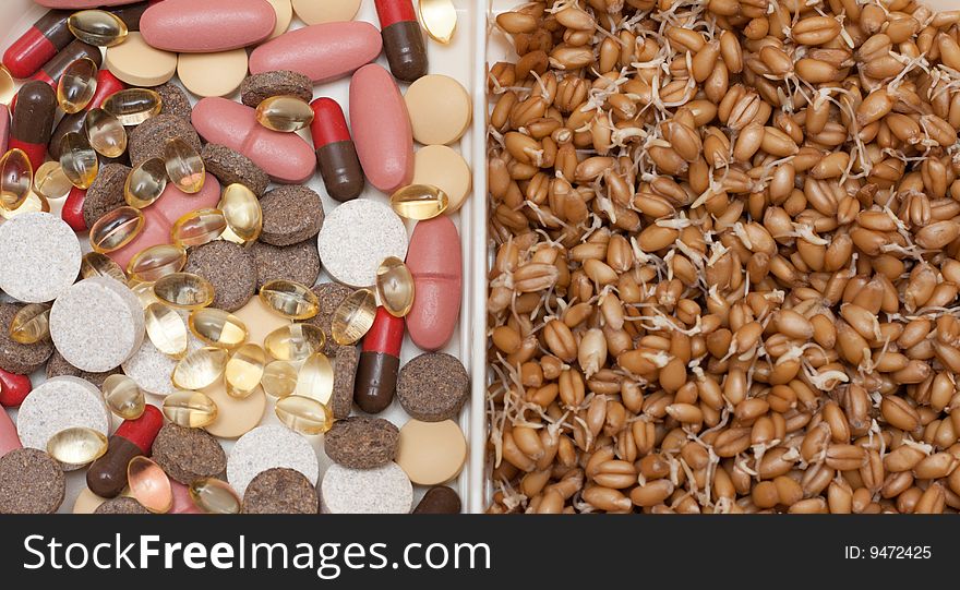 Container with pill, tablet and wheat on white background. Container with pill, tablet and wheat on white background