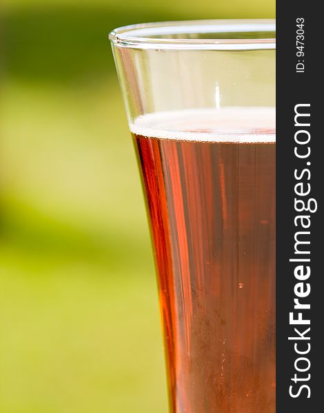 Glass beer on green background