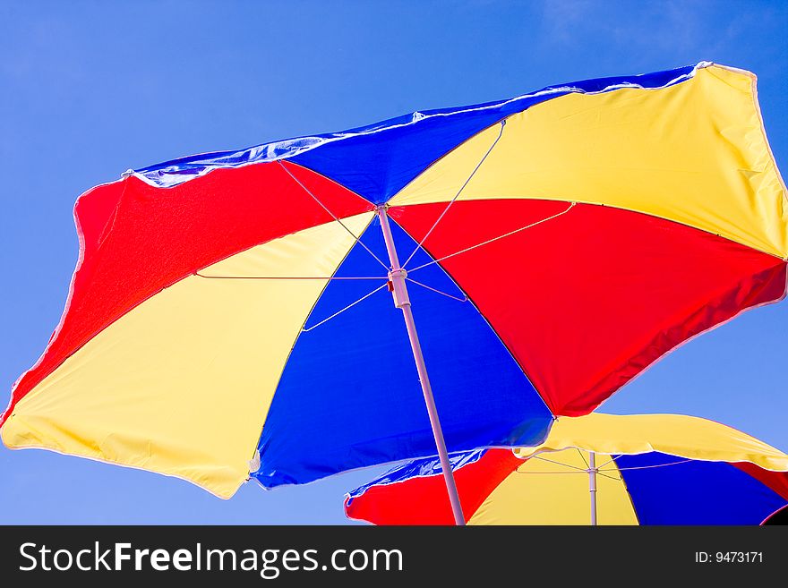 Sunshade on background of the blue sky