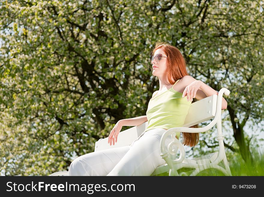 Woman relax under blossom tree in summer