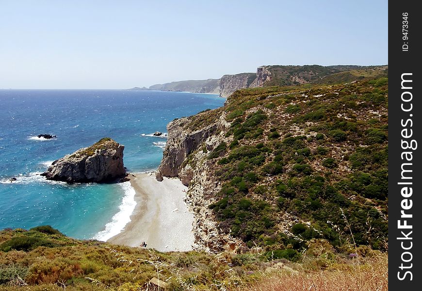 A beach on a deserted coastline in the mediterranean sea. A beach on a deserted coastline in the mediterranean sea.