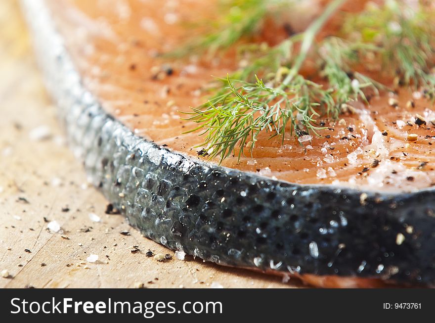 Raw salmon fillet on an old wooden kitchen board