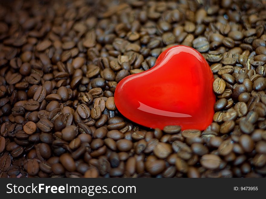 Red heart shine on the coffes bean. Red heart shine on the coffes bean