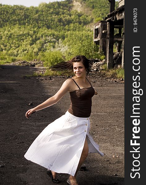 Young happy woman in a white dress dancing. Young happy woman in a white dress dancing