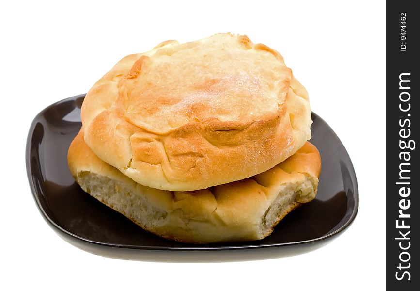 Close-up russian  bread loaf stacked on a black plate on white background