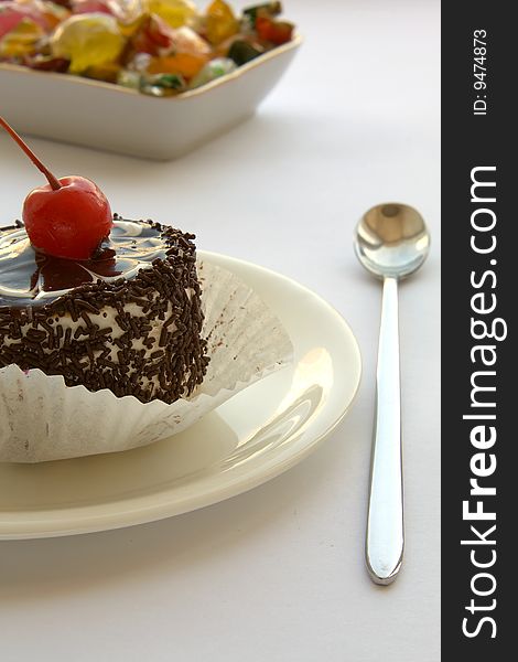 Chocolate cake with cherry and fruit candy