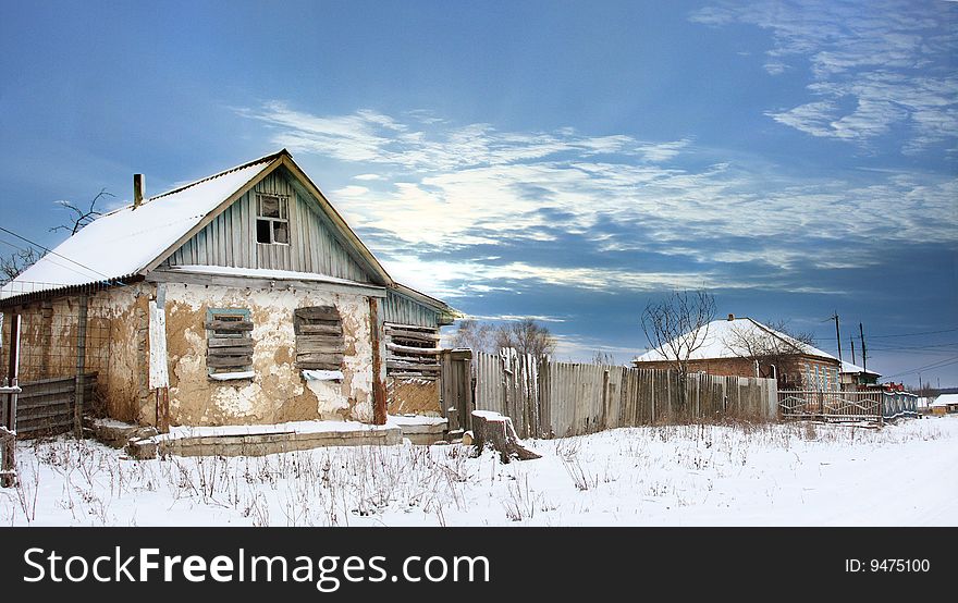 Destroy house in snow under blue sky