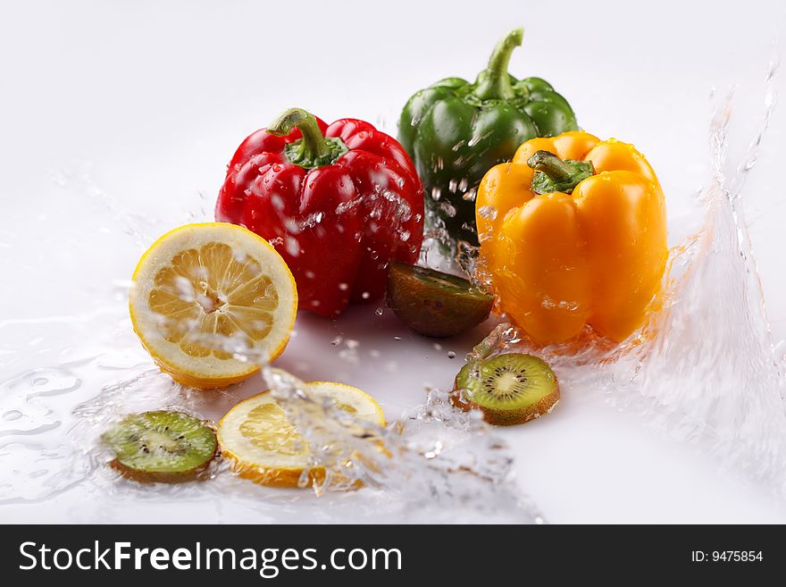 Lemon, pepper and kiwi in water. Lemon, pepper and kiwi in water