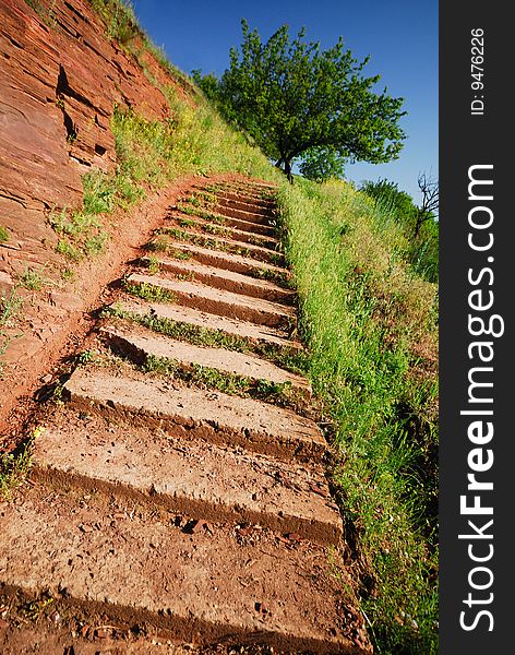 Concrete steps for pedestrians in hilly district,  green tree and  blue sky