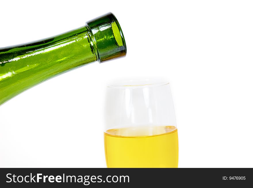 Pouring some white wine in glass, isolated on white