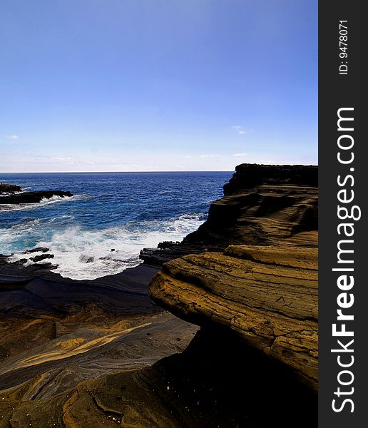 This is a picture of a canyon of volcanic rock against a blue sky in hawaii.