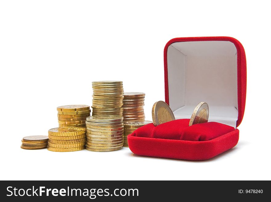 Several piles of coins and jewelry box isolated on white